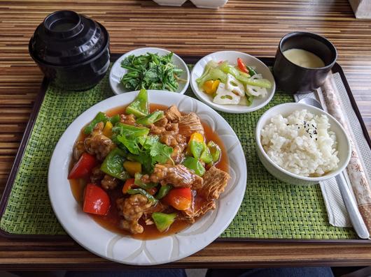Set mit einem Telleer mit Reisgericht und mehreren Schälchen mit weiteren Zutaten